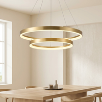 Remo Twin-Ring Pendant Light hanging over a pale oak dining table in a cream dining room