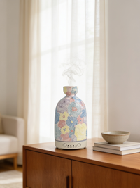 Aura ceramic diffuser in Pastel Floral finish on an oak sideboard