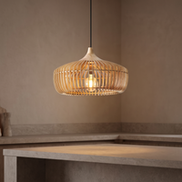 Muno slatted wood pendant light lit above a stone kitchen island in a warm neutral kitchen