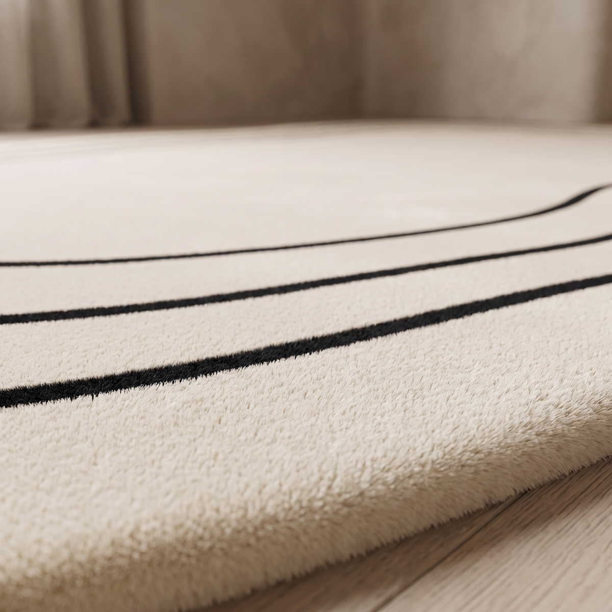 Macro close-up of the Ovala rug surface showing the dense short cream polyester pile and the crisp edges of two fine black border lines