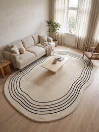 Overhead view of the 200 x 300 cm Ovala rug filling a living room, with a three-seat sofa, coffee table and armchair showing its scale