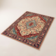 Sora Bohemian Velvet Rug laid flat on a pale studio floor, cream-ivory field with a teal centre medallion and deep navy floral border