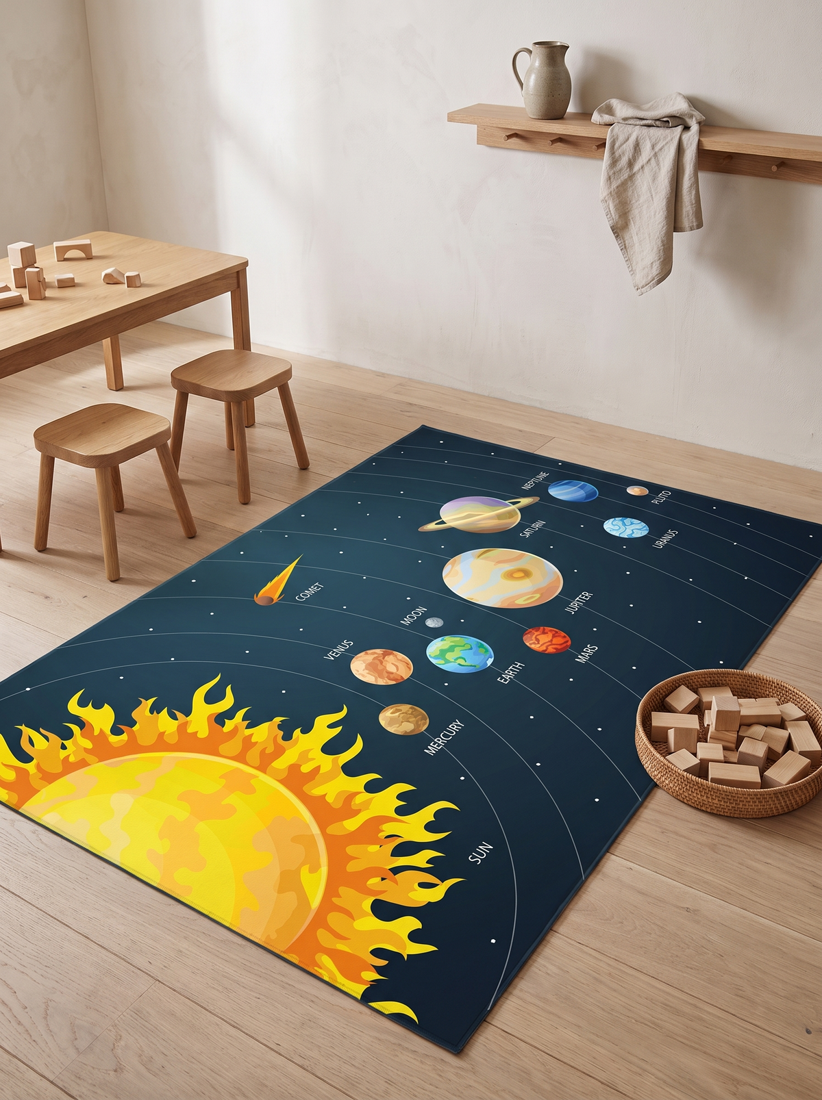 Orbit Solar System Rug in a playroom corner beside a low oak play table, stools and a basket of wooden blocks