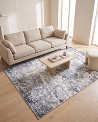Marlo rug shown in scale beneath a three-seat linen sofa and a low oak coffee table on a pale oak floor