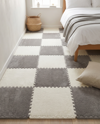Tessa modular plush rug tiles laid as a soft standing area beside a low oak bed in a calm neutral bedroom