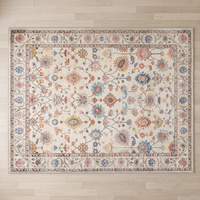 Overhead view of the full Bahia rug on pale oak boards, showing the complete botanical field and cornered multi-band border