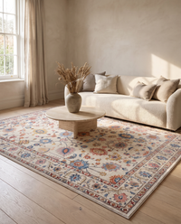 Bahia Bohemian Velvet Rug anchoring a warm neutral living room with a cream boucle sofa, travertine coffee table and pale oak floor