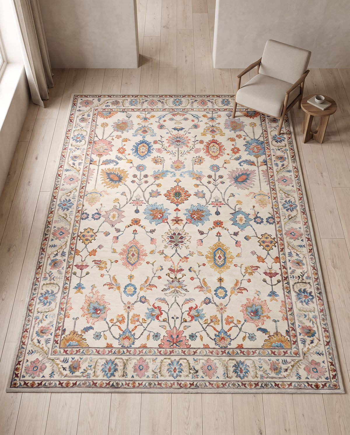 Scale reference of the 160 by 230 cm Bahia rug on an oak floor beside a standard armchair and small round side table