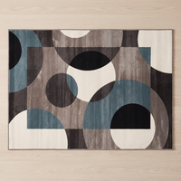 Overhead view of the Lindo rug showing the full geometric pattern of circles and rectangles in petrol, taupe, charcoal and off-white