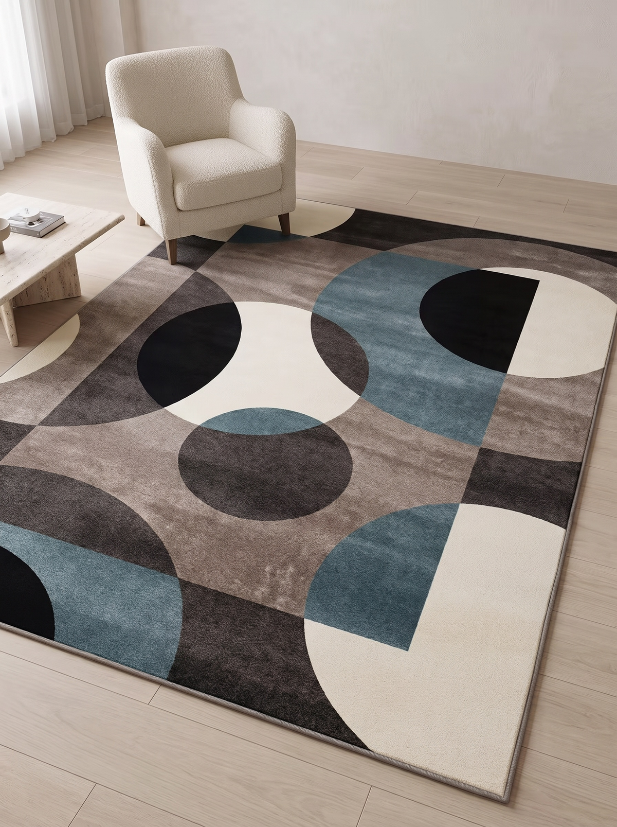 Lindo rug shown beside a boucle armchair and low coffee table, giving a sense of its 120 x 160 cm scale