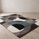 Lindo petrol geometric flannel rug laid flat on a pale oak floor against a plaster wall, showing the full 120 x 160 cm rectangle