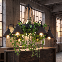 Corven six-arm ceiling light lit above a timber kitchen island in an industrial loft at dusk