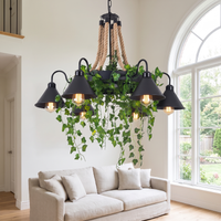 Corven six-arm ceiling light hanging in a bright double-height living room above a pale linen sofa