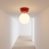 Red Vellona Petite ceiling light lighting a white hallway with a pale oak floor