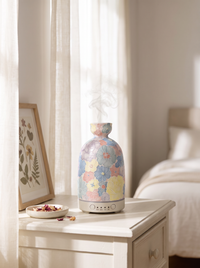 Aura Ceramic Stone Diffuser in Pastel Floral on a white bedroom dresser