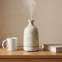 Aura Ceramic Stone Diffuser – size shown beside a standard mug and hardcover book