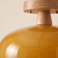 Charo Wood Cap Glass Ceiling Light - macro close-up of amber glass dome and oak wood cap texture