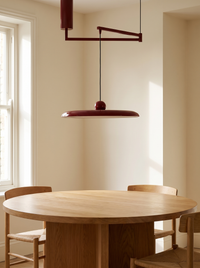 Fluxa Morandi Arm Pendant Light - scale context over round oak dining table with chairs
