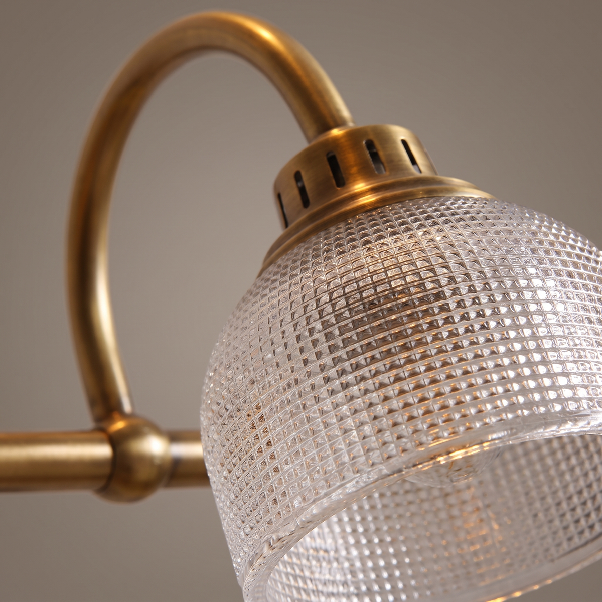 Prisa Prismatic Vanity Wall Light - macro close-up of prismatic glass texture and antique brass arm