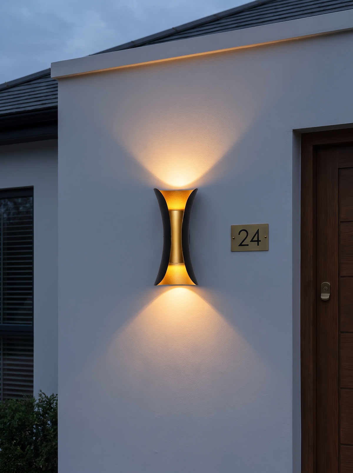 Corva Curved Outdoor Wall Light - dusk lifestyle on rendered exterior wall glowing warm amber beside house number