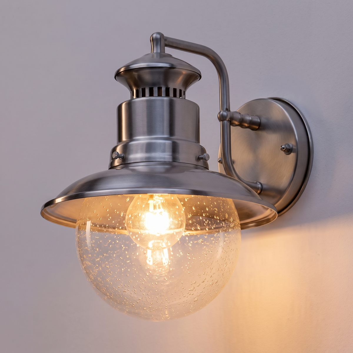 Gwena Outdoor Wall Light - close-up glowing seeded glass globe warm light