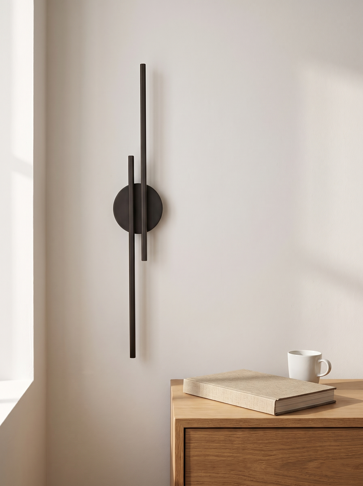 Eldra Disc Wall Light scale reference beside oak bedside table with book and mug, natural daylight