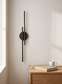 Eldra Disc Wall Light scale reference beside oak bedside table with book and mug, natural daylight