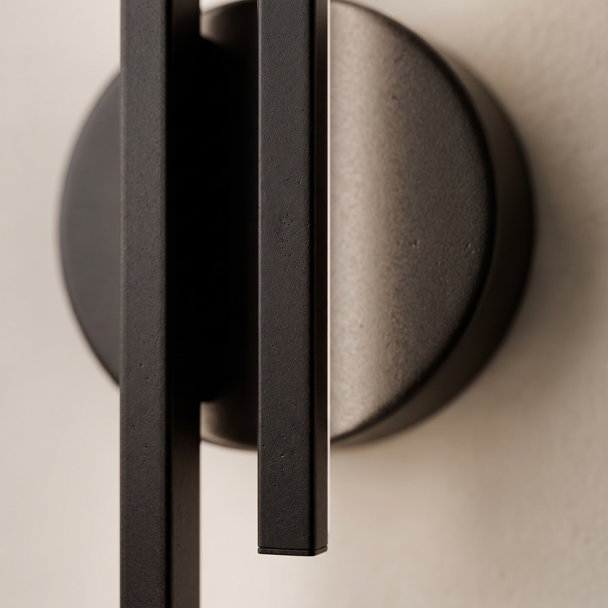 Eldra Disc Wall Light macro detail - twin matte black bars and circular disc backplate on cream wall