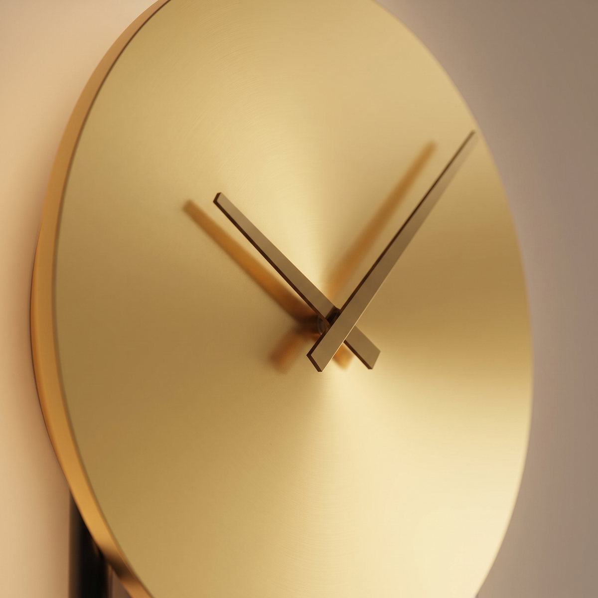 Kalve Clock Wall Light - close-up of satin gold clock face with minimal brass hands