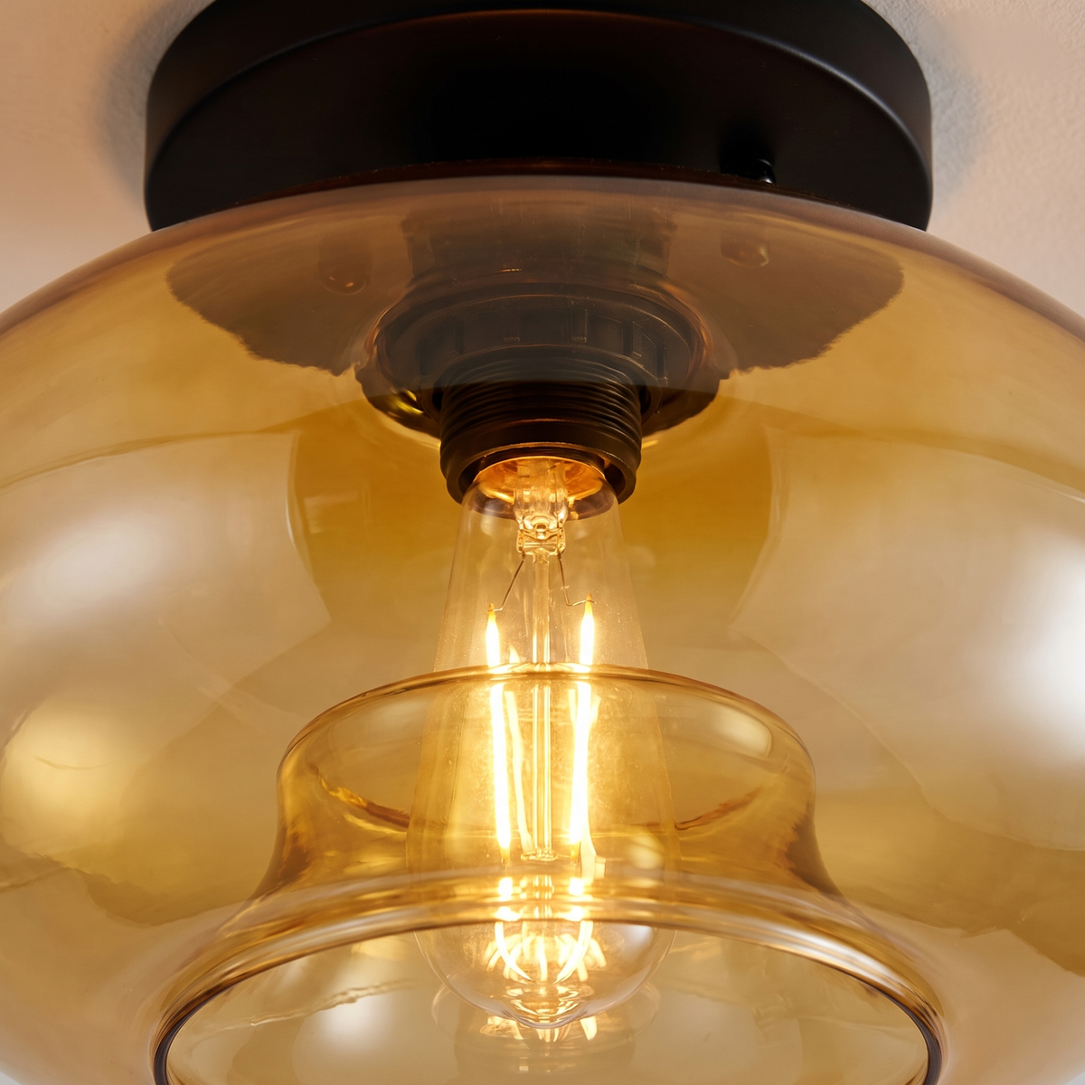 Valto Globe Ceiling Light - amber glass macro close-up showing filament and cognac glass detail