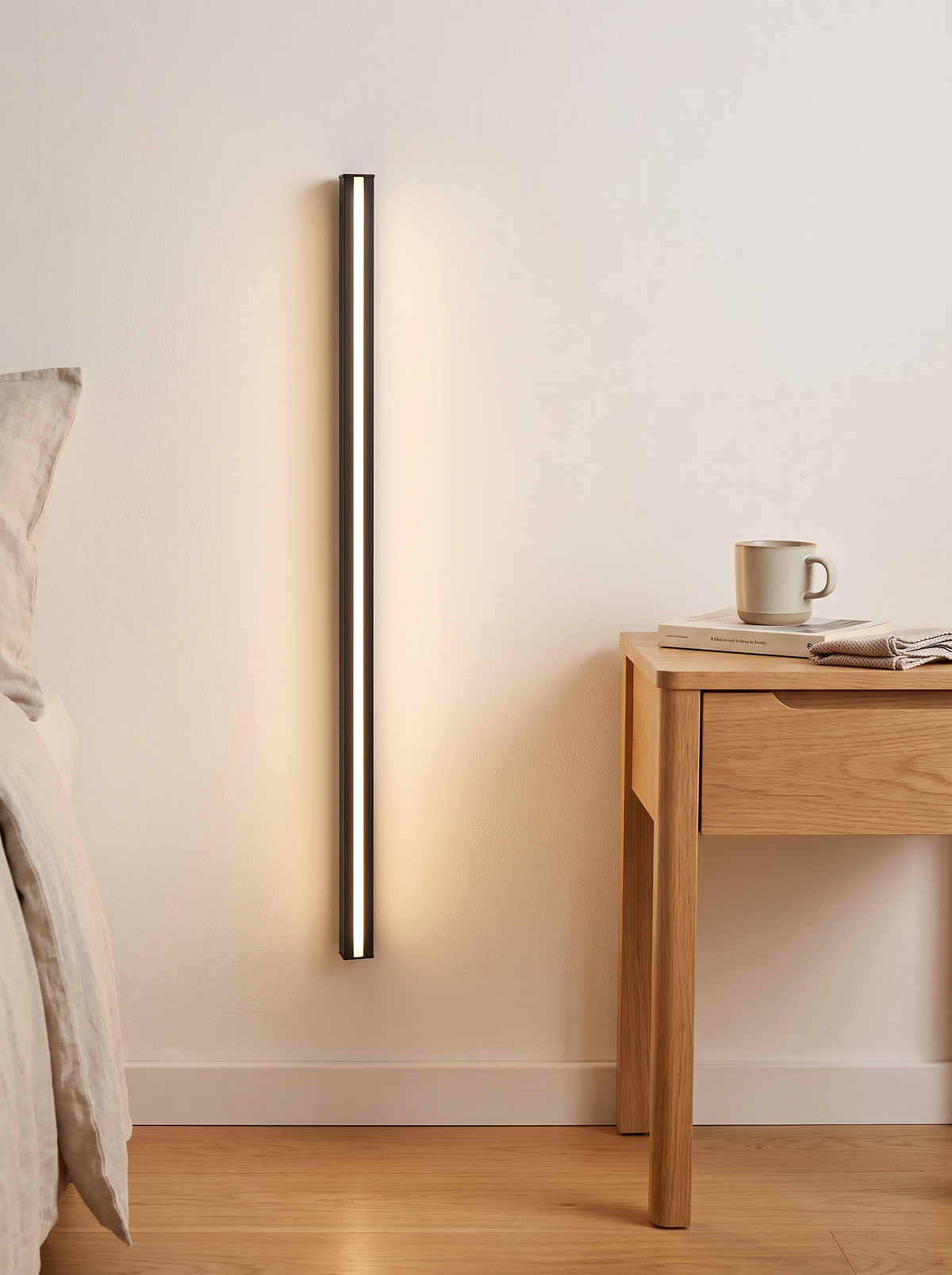 Granto Linear Wall Light - scale shot beside bedroom table showing 60cm length