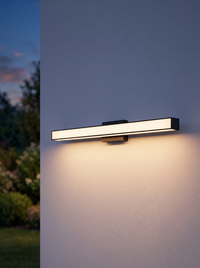 Sela Linear Outdoor Wall Light - dusk facade, warm glow on render wall