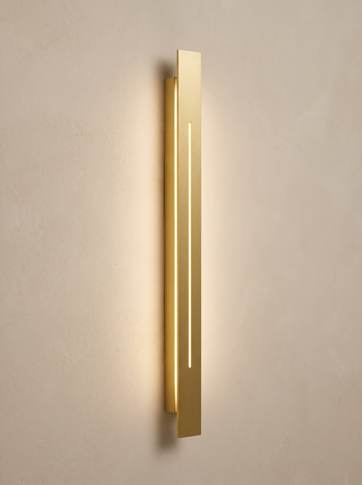 Azino Slim LED Wall Light - angled three-quarter view on cream plaster wall showing depth and warm 2700K glow