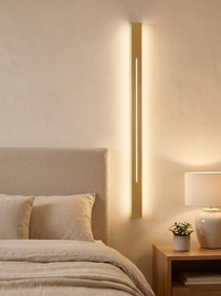 Azino Slim LED Wall Light - scale shot mounted beside linen bed headboard showing full 60cm length in bedroom context