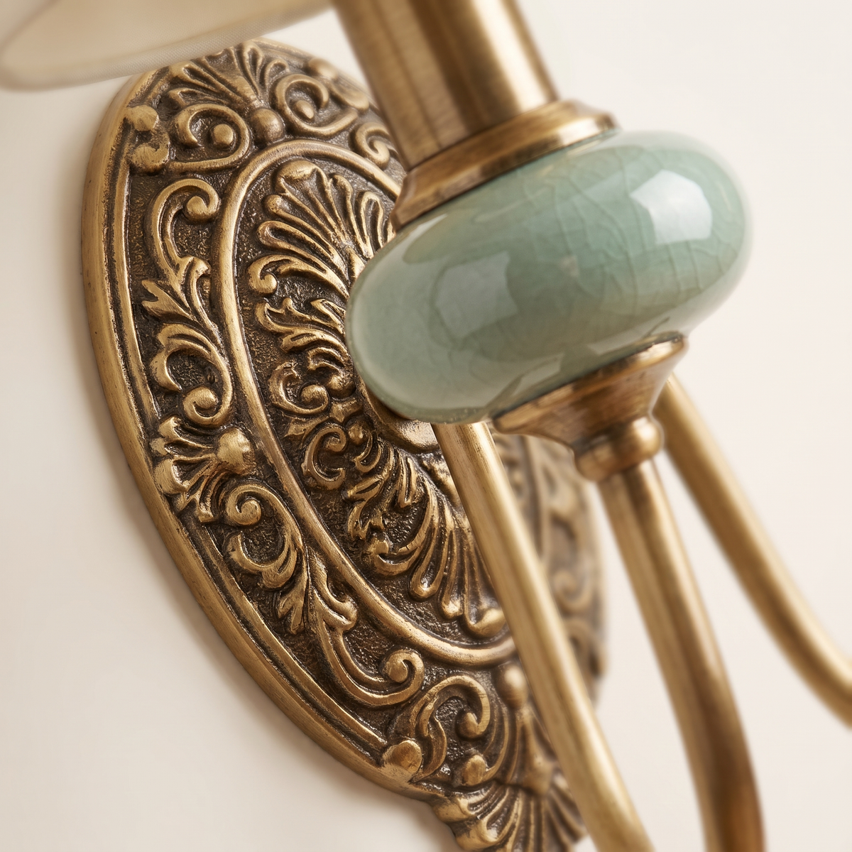 Orla Twin Fabric Shade Wall Light - macro close-up of celadon ceramic bead and ornate antique brass backplate
