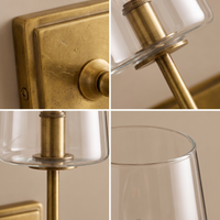 Torin Clear Glass Wall Sconce - macro detail of aged brass backplate texture and clear glass rim