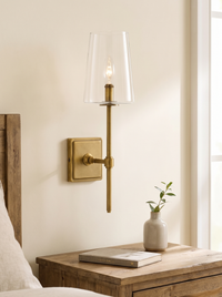 Torin Clear Glass Wall Sconce - scale lifestyle shot above timber bedside table with book and bud vase