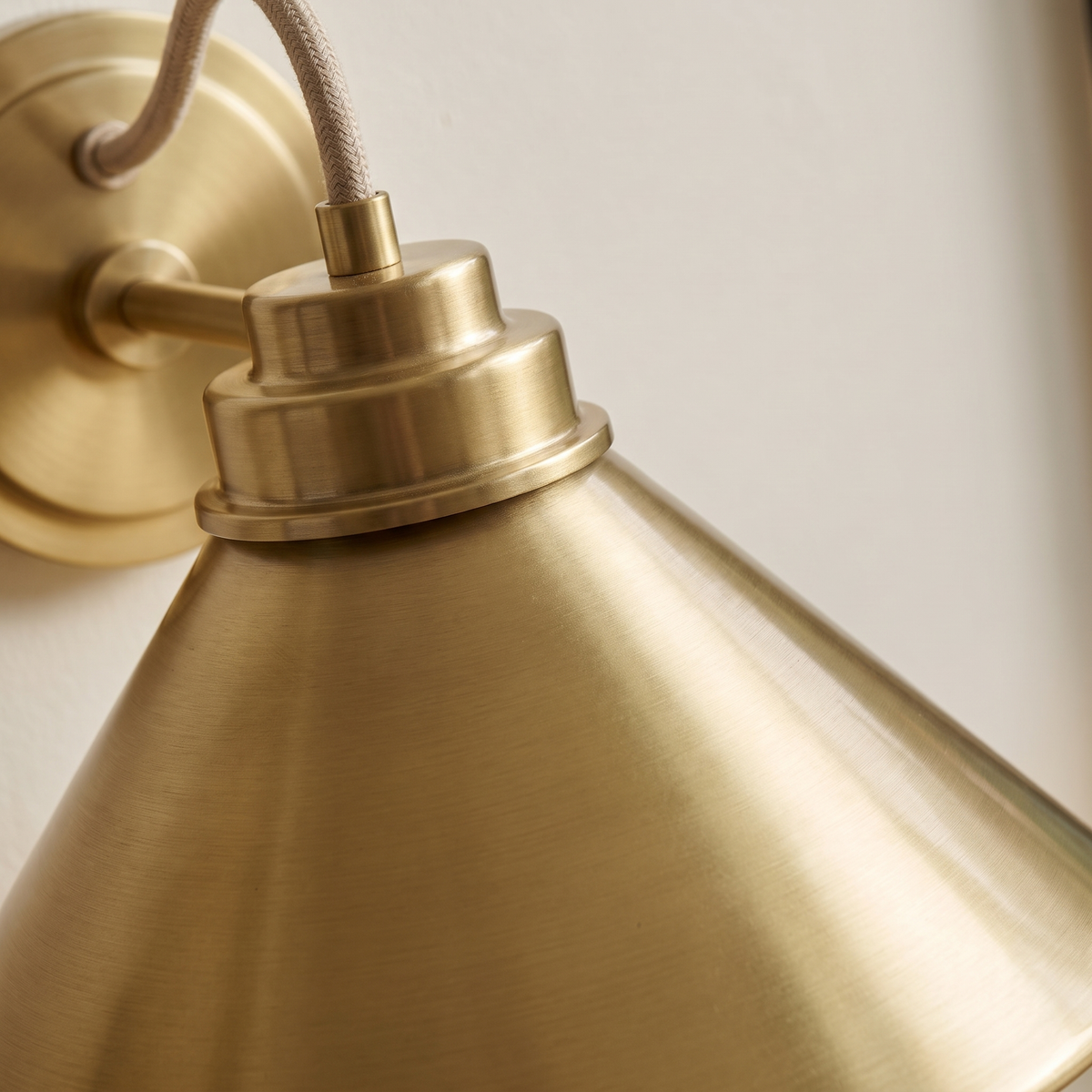 Arvo Bronze Cone Wall Light - macro close-up of brushed brass cone and rope-wrapped flex