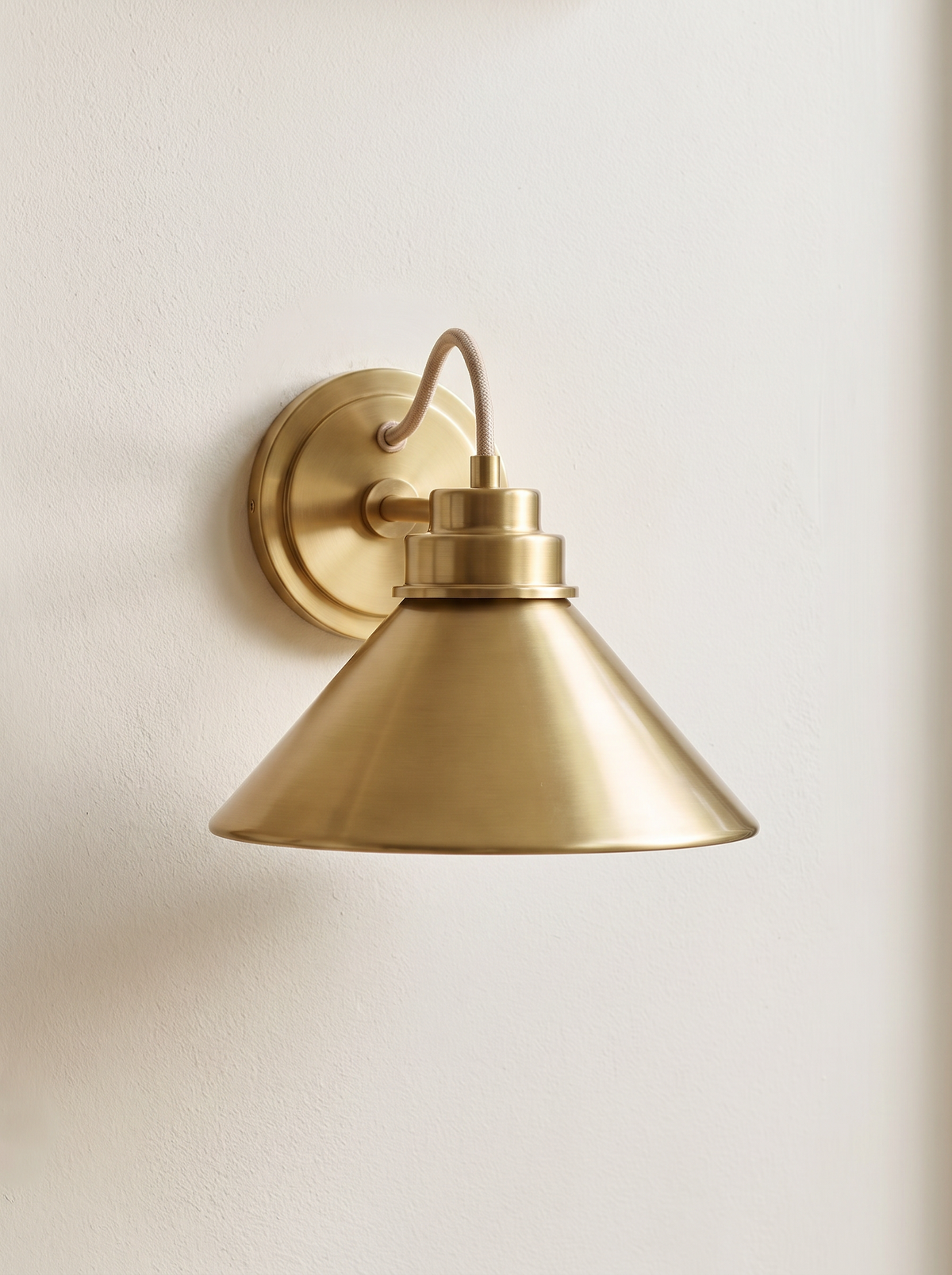 Arvo Bronze Cone Wall Light - clean editorial shot on cream wall, unlit