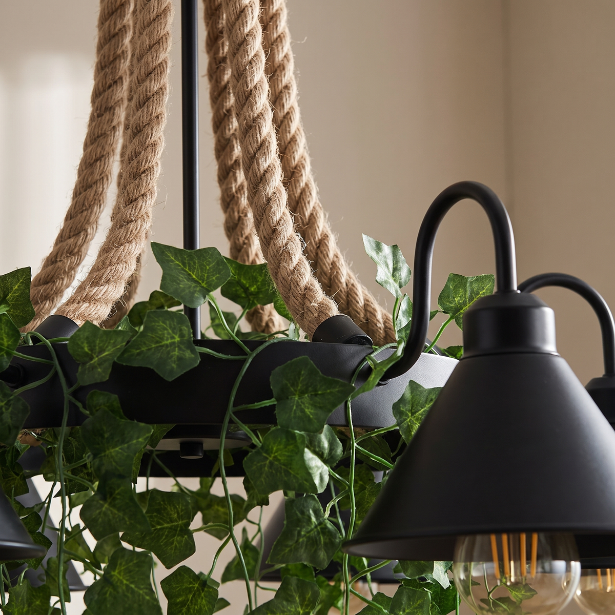 Corven Six-Arm Ceiling Light - macro close-up of twisted hemp rope cords and ivy leaves detail beside matte-black cone shade