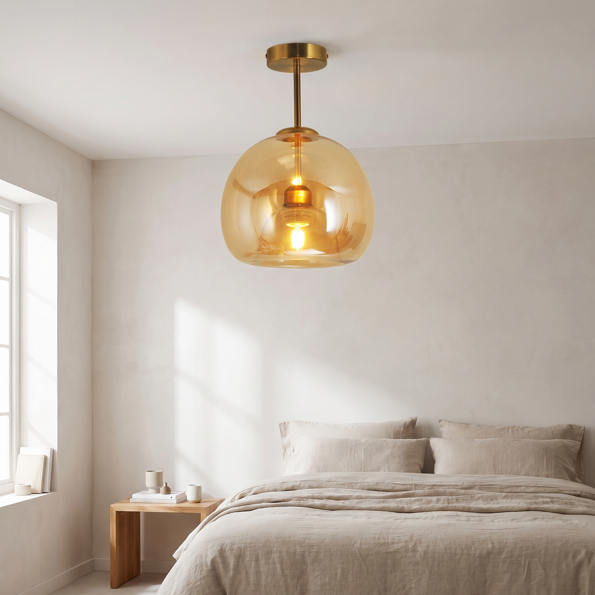 Belvo amber glass ceiling light lit above a linen bed in a bright plaster walled bedroom