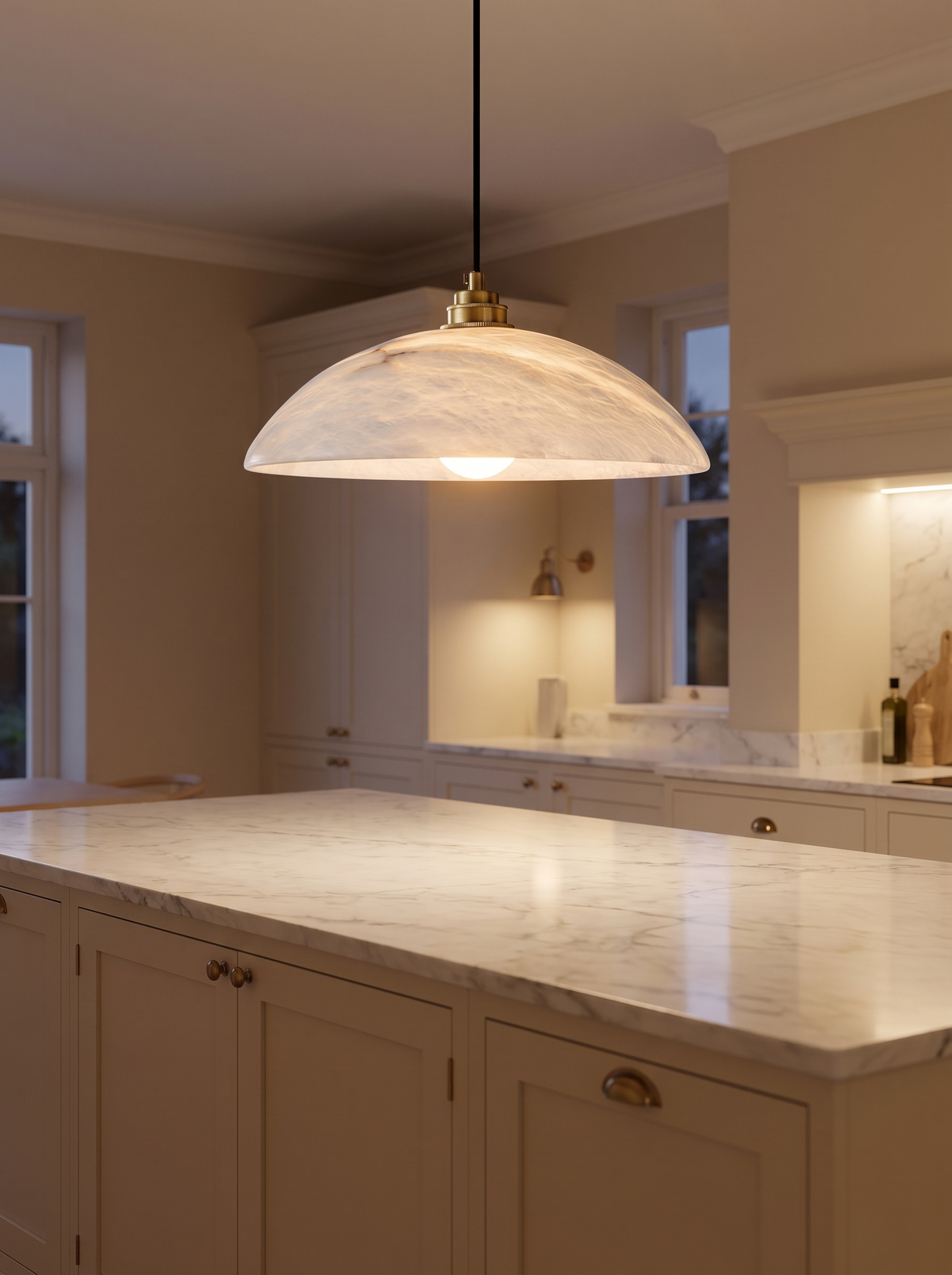 Delo Alabaster Dome Pendant Light - lifestyle shot over marble kitchen island at dusk