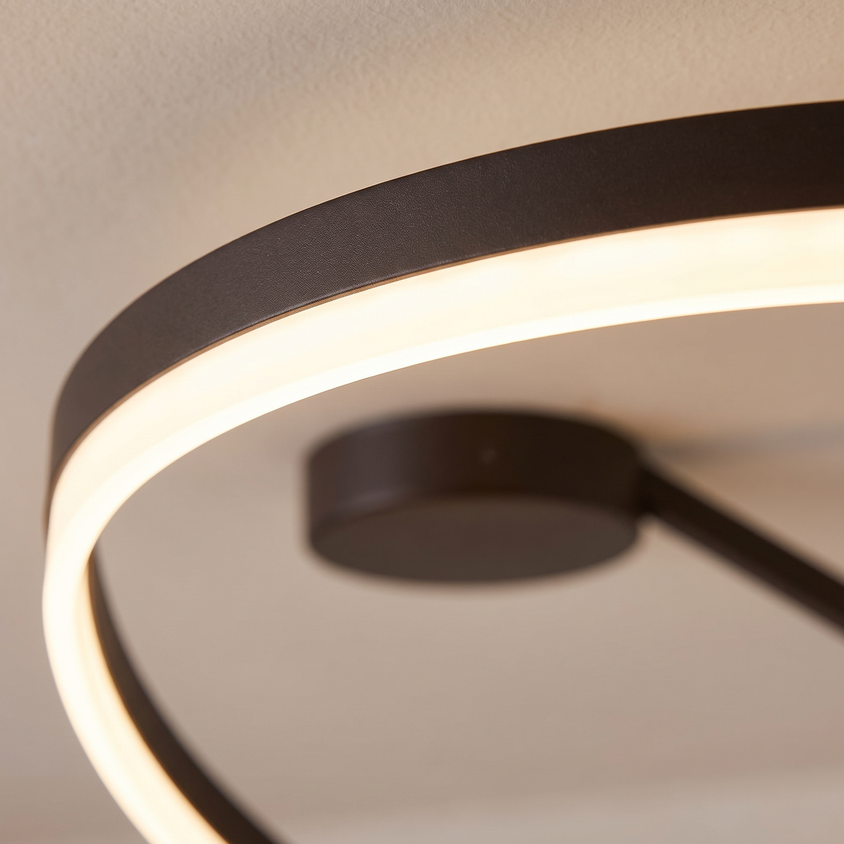 Soleno Circle Ceiling Light - macro close-up of LED acrylic diffuser band glowing warm white against cream plaster ceiling