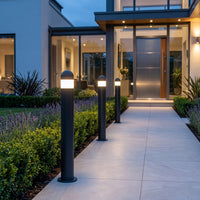 Lena pedestal lights along a garden path at dusk