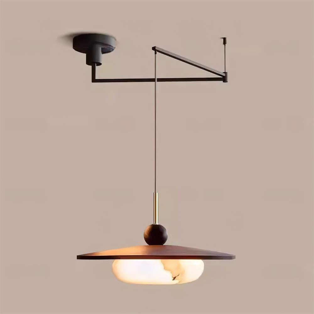 Turlo pendant light lit against a warm neutral wall, showing the glow through the imitation alabaster diffuser
