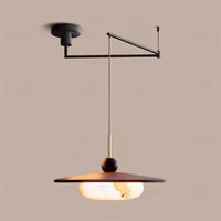 Turlo pendant light lit against a warm neutral wall, showing the glow through the imitation alabaster diffuser