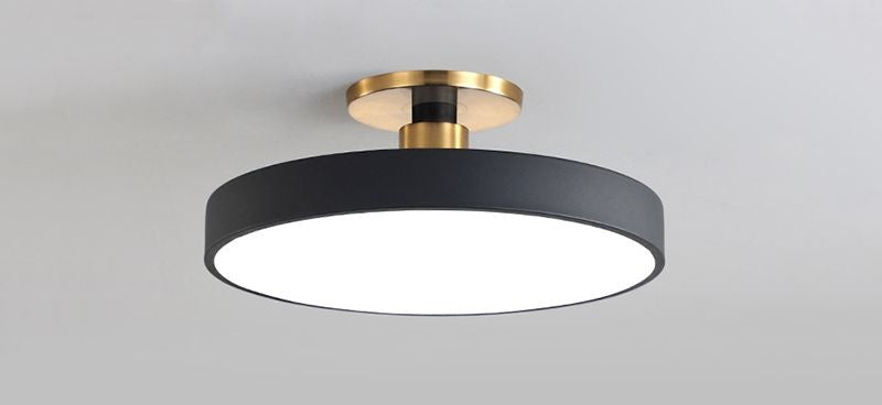 Nelo round black ceiling light angled view showing drum profile and brass stem