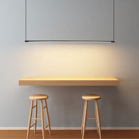 Zyno Linear Pendant Light lit above a timber breakfast bar with two wooden stools