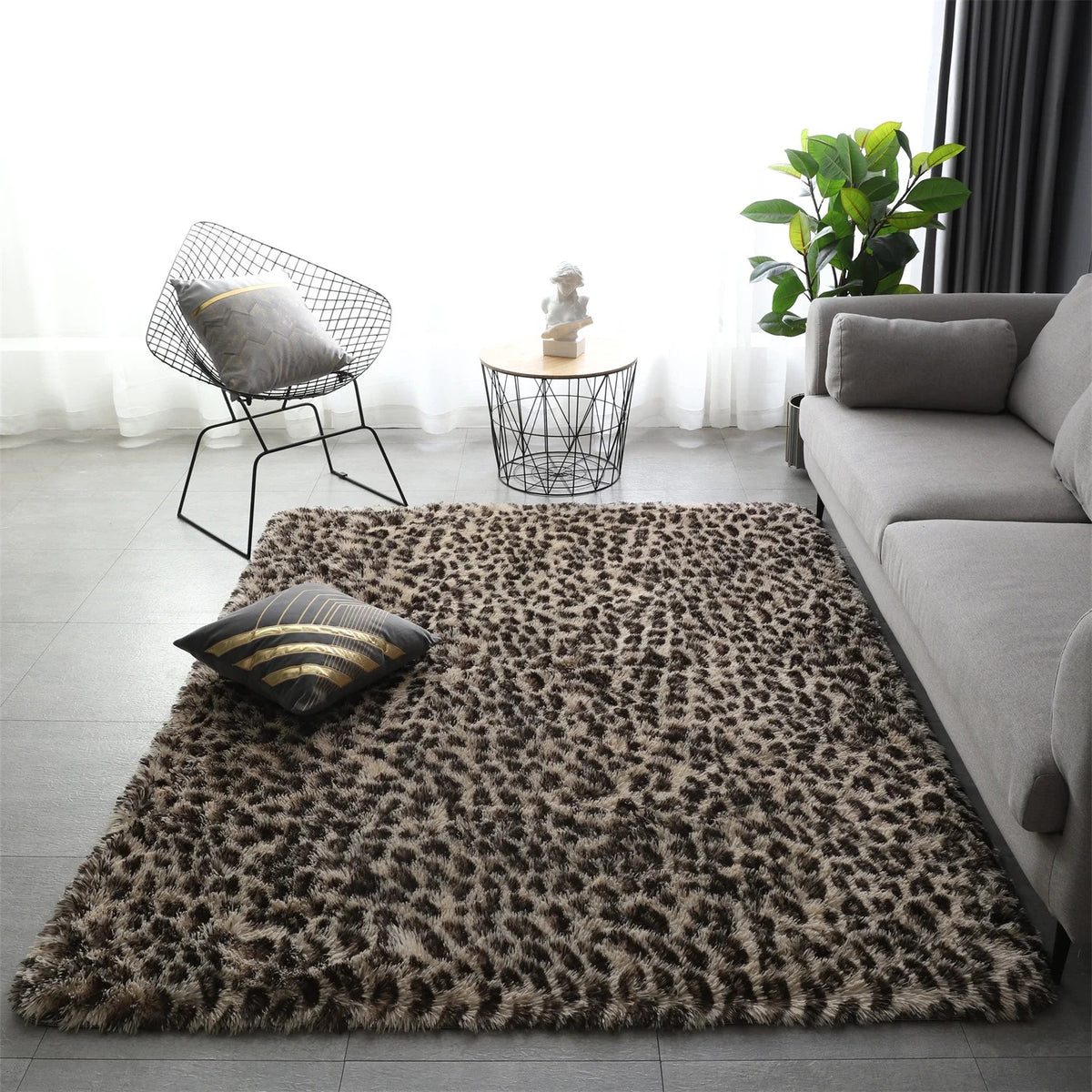 Wider view of the Fauna Shag Rug set out in front of a sofa, the leopard pattern running edge to edge