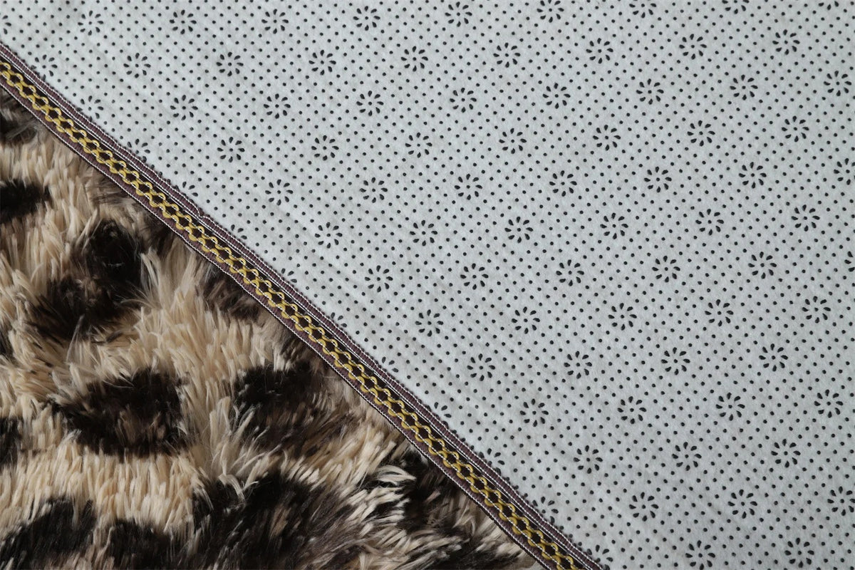 Underside of the Fauna Shag Rug folded back to show the ethylene vinyl acetate backing and the overlocked binding tape along the edge
